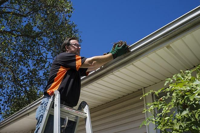 gutter repair technician using a power drill in Brandenburg